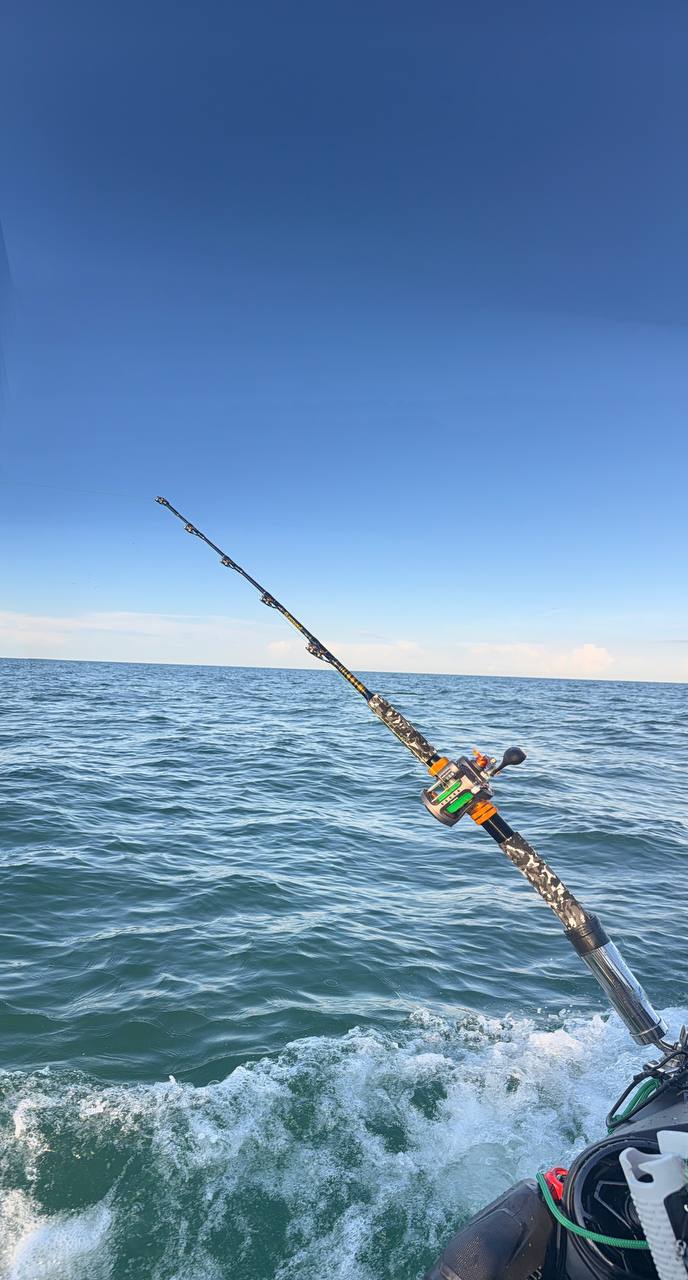 Fishing rod angled over choppy water